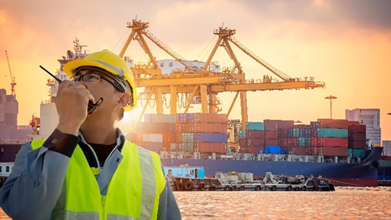 worker at port talking into a walkie talkie