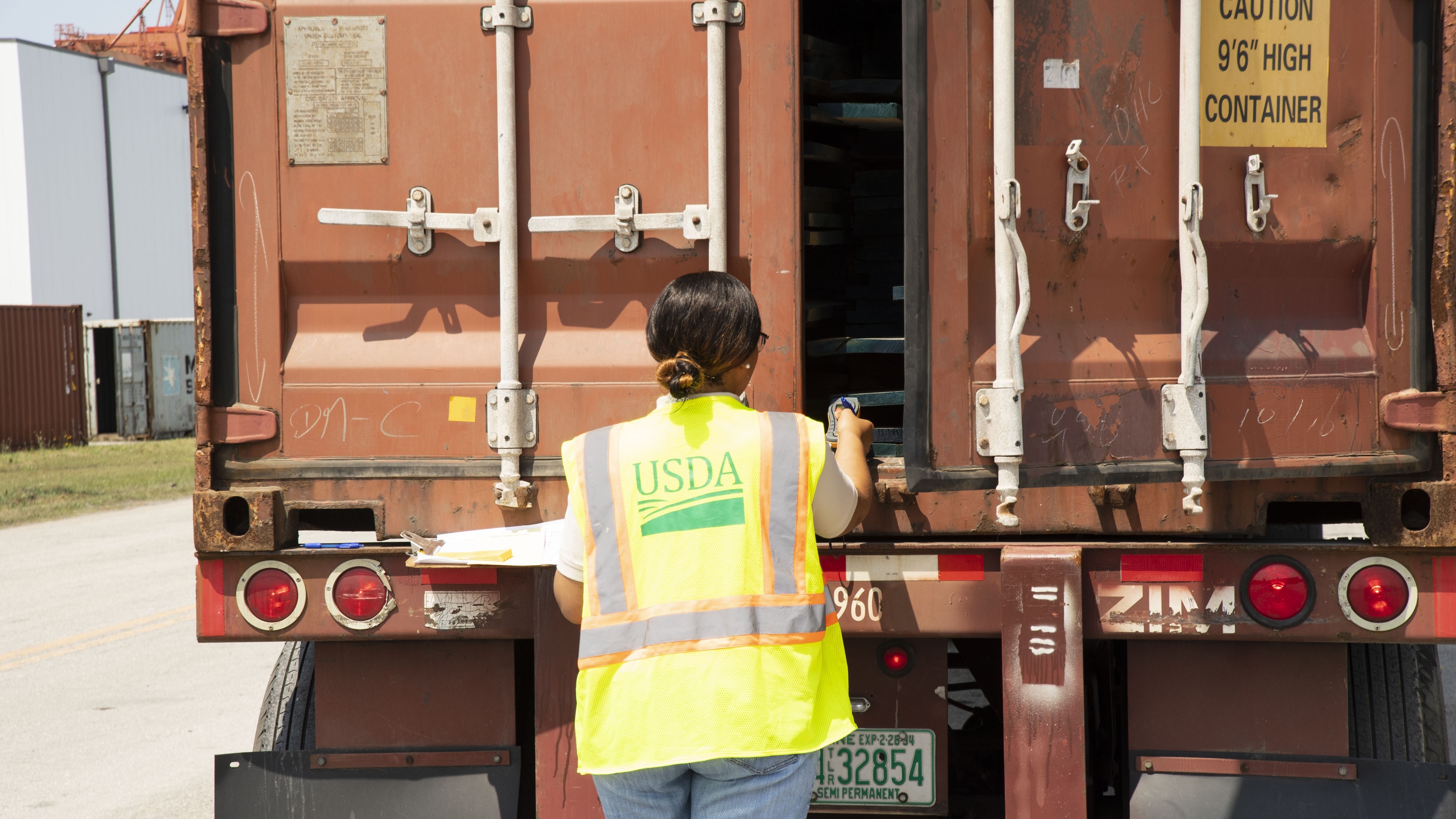 a USDA worker investigating inside of a truck