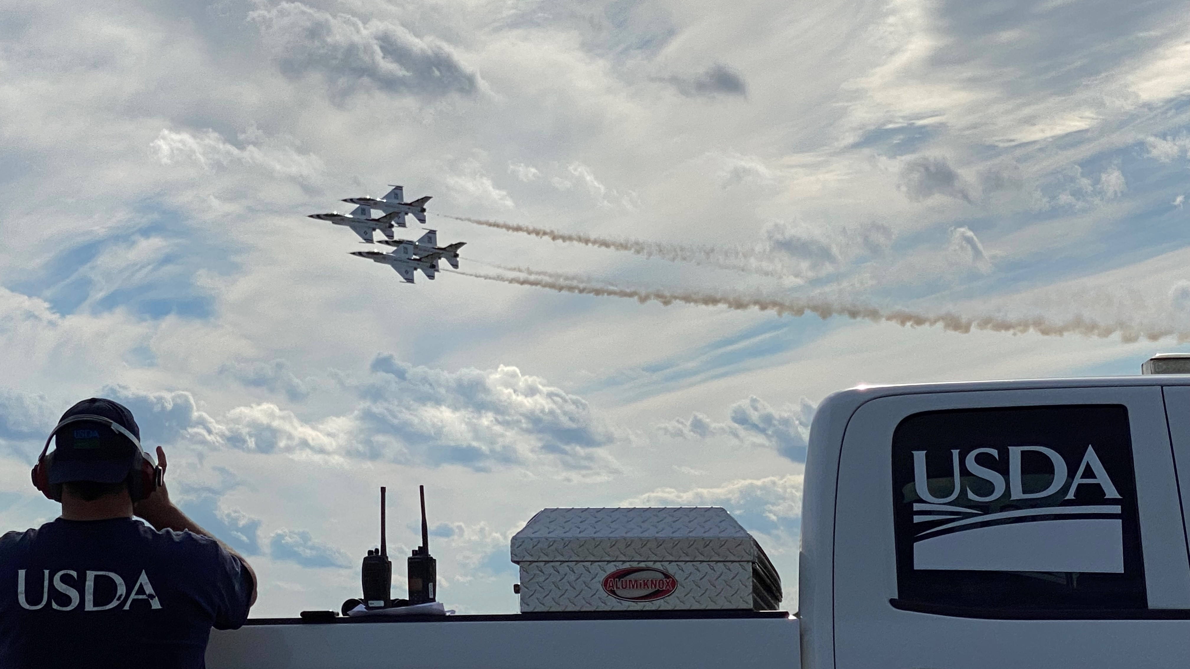 A USDA employee observing an air show