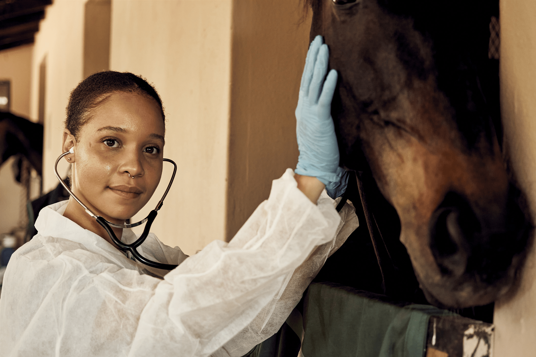 Female student standing next to a horse