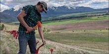 man installing barrier in field